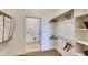 Well-organized walk-in closet with ample storage, rods, and shelves, plus a laundry area at 935 W 128Th Pl, Westminster, CO 80234