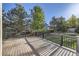 Backyard deck with dark railing and view of the trees, grass, and neighborhood at 2660 Timberchase Trl, Highlands Ranch, CO 80126