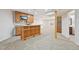 Finished basement with a bar, wood cabinets, and a flat screen television at 2660 Timberchase Trl, Highlands Ranch, CO 80126