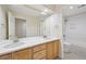 Bright bathroom featuring double sinks, light wood cabinets and a shower and bathtub combination at 2660 Timberchase Trl, Highlands Ranch, CO 80126