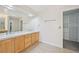 Bathroom featuring double vanity, tiled floor, and walk-in closet with shelving at 2660 Timberchase Trl, Highlands Ranch, CO 80126