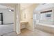 Bright bathroom featuring a makeup vanity with Hollywood lighting, a soaking tub and shower at 2660 Timberchase Trl, Highlands Ranch, CO 80126