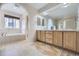 Bright bathroom with double sinks, a soaking tub, and a large mirror for ample lighting at 2660 Timberchase Trl, Highlands Ranch, CO 80126