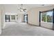 Spacious bedroom featuring tall ceilings, large windows with backyard views, and carpeted floor at 2660 Timberchase Trl, Highlands Ranch, CO 80126