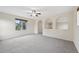 Open bonus room with arches and large windows allowing for natural light to brighten the space at 2660 Timberchase Trl, Highlands Ranch, CO 80126