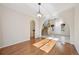 Elegant dining room with hardwood floors, an arched doorway, and a decorative chandelier at 2660 Timberchase Trl, Highlands Ranch, CO 80126