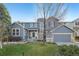Charming two-story home featuring blue siding, a well-manicured lawn, and an attached two-car garage at 2660 Timberchase Trl, Highlands Ranch, CO 80126
