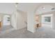 Hallway featuring arched doorways, neutral paint, carpet, and an integrated desk space at 2660 Timberchase Trl, Highlands Ranch, CO 80126