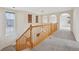 Bright hallway with railing and large windows and archway design elements at 2660 Timberchase Trl, Highlands Ranch, CO 80126