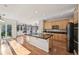Modern kitchen features wood cabinetry, black countertops, and stainless steel appliances at 2660 Timberchase Trl, Highlands Ranch, CO 80126