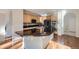 Spacious kitchen featuring wooden cabinets, a black tile backsplash, and a large kitchen island at 2660 Timberchase Trl, Highlands Ranch, CO 80126