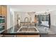 Close-up view of the kitchen island featuring a double sink and dark countertops at 2660 Timberchase Trl, Highlands Ranch, CO 80126