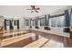 Bright and airy living room with many windows, hardwood floors, and natural light at 2660 Timberchase Trl, Highlands Ranch, CO 80126