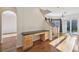 Bright living room with hardwood floors, built-in desk, and staircase at 2660 Timberchase Trl, Highlands Ranch, CO 80126