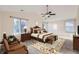 Spacious main bedroom featuring vaulted ceilings, a ceiling fan, and large windows for plenty of natural light at 2660 Timberchase Trl, Highlands Ranch, CO 80126