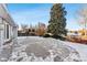 Spacious backyard patio with snow cover, ideal for outdoor entertaining at 10401 W Lehigh Ave, Denver, CO 80235