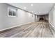 Spacious finished basement with wood-look floors and a fireplace at 10401 W Lehigh Ave, Denver, CO 80235