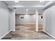 Open floor plan in finished basement with wood-look flooring at 10401 W Lehigh Ave, Denver, CO 80235