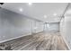 Finished basement with gray walls and wood-look flooring at 10401 W Lehigh Ave, Denver, CO 80235