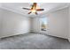 Bright bedroom featuring grey carpeting and a ceiling fan at 10401 W Lehigh Ave, Denver, CO 80235