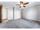 Bedroom with ceiling fan, double door closet, and carpeting at 10401 W Lehigh Ave, Denver, CO 80235