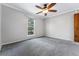 Spacious bedroom with ceiling fan and large window at 10401 W Lehigh Ave, Denver, CO 80235