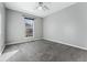 Well-lit bedroom with carpet flooring and a ceiling fan at 10401 W Lehigh Ave, Denver, CO 80235