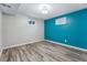 Spacious finished basement bedroom with teal accent wall at 10401 W Lehigh Ave, Denver, CO 80235