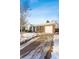 Front view of a ranch home with a driveway, snow on the ground at 10401 W Lehigh Ave, Denver, CO 80235