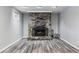 Cozy stone fireplace in finished basement with wood-look flooring at 10401 W Lehigh Ave, Denver, CO 80235