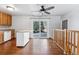 Bright kitchen with wood cabinets, island, and sliding glass door to backyard at 10401 W Lehigh Ave, Denver, CO 80235