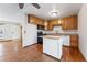 Kitchen boasts wood cabinets, an island, and access to living room at 10401 W Lehigh Ave, Denver, CO 80235