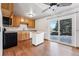 Kitchen with wood cabinets, island, and view to backyard from sliding glass doors at 10401 W Lehigh Ave, Denver, CO 80235