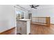 Kitchen with island and sliding glass doors leading to patio at 10401 W Lehigh Ave, Denver, CO 80235