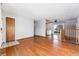 Living area showing hardwood floors and access to other rooms at 10401 W Lehigh Ave, Denver, CO 80235