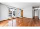 Hardwood floor living room with entryway and view to another room at 10401 W Lehigh Ave, Denver, CO 80235