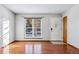 Living room with hardwood floors, large window, and entryway at 10401 W Lehigh Ave, Denver, CO 80235