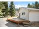 Spacious wooden deck with steps, ideal for outdoor enjoyment and relaxation at 10039 S Turkey Creek Rd, Morrison, CO 80465