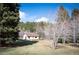 Exterior home view surrounded by trees, with a small deck attached at 10039 S Turkey Creek Rd, Morrison, CO 80465