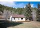 Exterior view showcasing the home with inviting outdoor deck, perfect for enjoying the scenic surroundings at 10039 S Turkey Creek Rd, Morrison, CO 80465