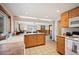 Well-lit kitchen features wood cabinets, tile floors, and a pass-through to the dining and entryway at 10039 S Turkey Creek Rd, Morrison, CO 80465