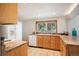 Functional kitchen with natural wood cabinets, tile floors, a window with a backyard view, and modern appliances at 10039 S Turkey Creek Rd, Morrison, CO 80465