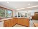Bright kitchen featuring wood cabinets, spacious countertops, and a sink overlooking a lush view at 10039 S Turkey Creek Rd, Morrison, CO 80465