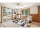 Bright and airy living space with sliding glass doors to the deck and comfortable seating overlooking the yard at 10039 S Turkey Creek Rd, Morrison, CO 80465