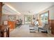 Bright living space with a bar-style kitchen, sliding glass doors to the deck, and cozy seating at 10039 S Turkey Creek Rd, Morrison, CO 80465