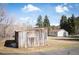 Exterior view of home with wooden storage shed in foreground at 10039 S Turkey Creek Rd, Morrison, CO 80465