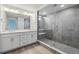 Modern bathroom with a double vanity, sleek fixtures, and a glass-enclosed shower at 9297 Truckee Ct, Commerce City, CO 80022