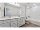 Bathroom showcasing double sinks, a large mirror, and a bathtub-shower combination at 9297 Truckee Ct, Commerce City, CO 80022