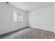 Bedroom featuring soft carpet and a window overlooking a neighboring home at 9297 Truckee Ct, Commerce City, CO 80022