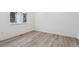 Bright bedroom featuring light wood flooring and a window letting in natural light at 9297 Truckee Ct, Commerce City, CO 80022